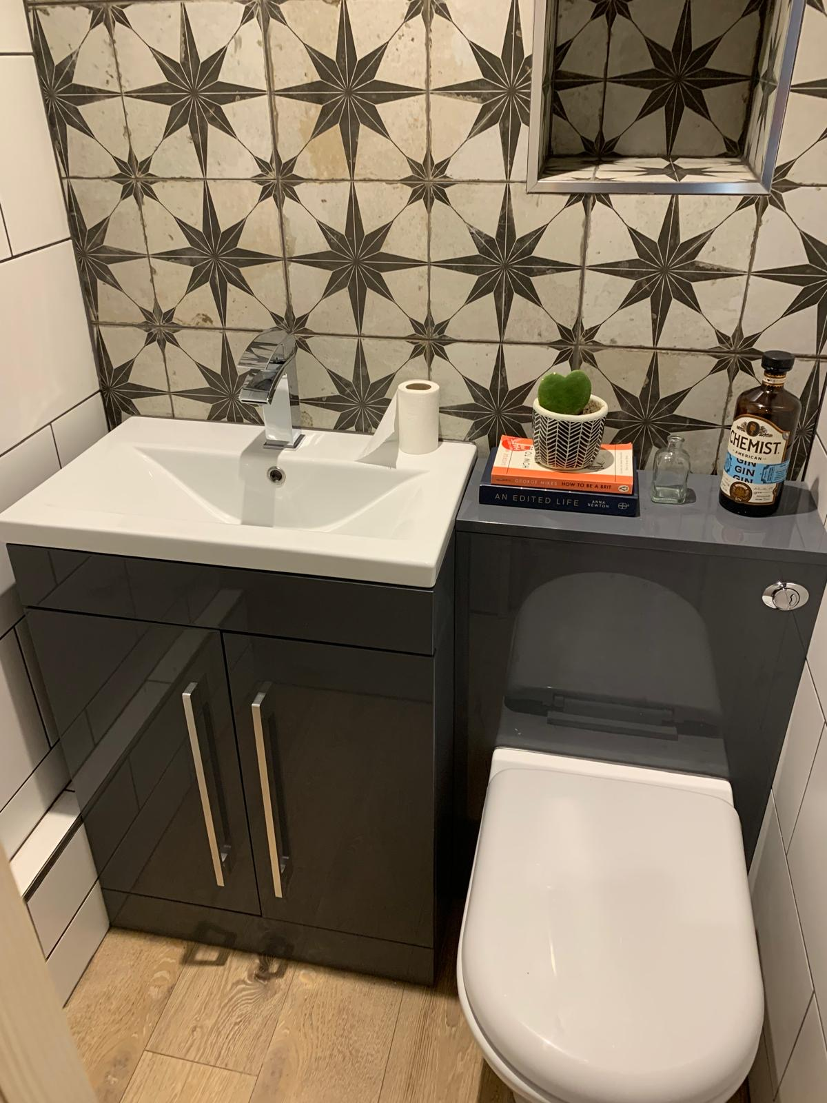 Feature wall tiling with recessed shelf in a finished cloakroom by AJ Plumbing Services