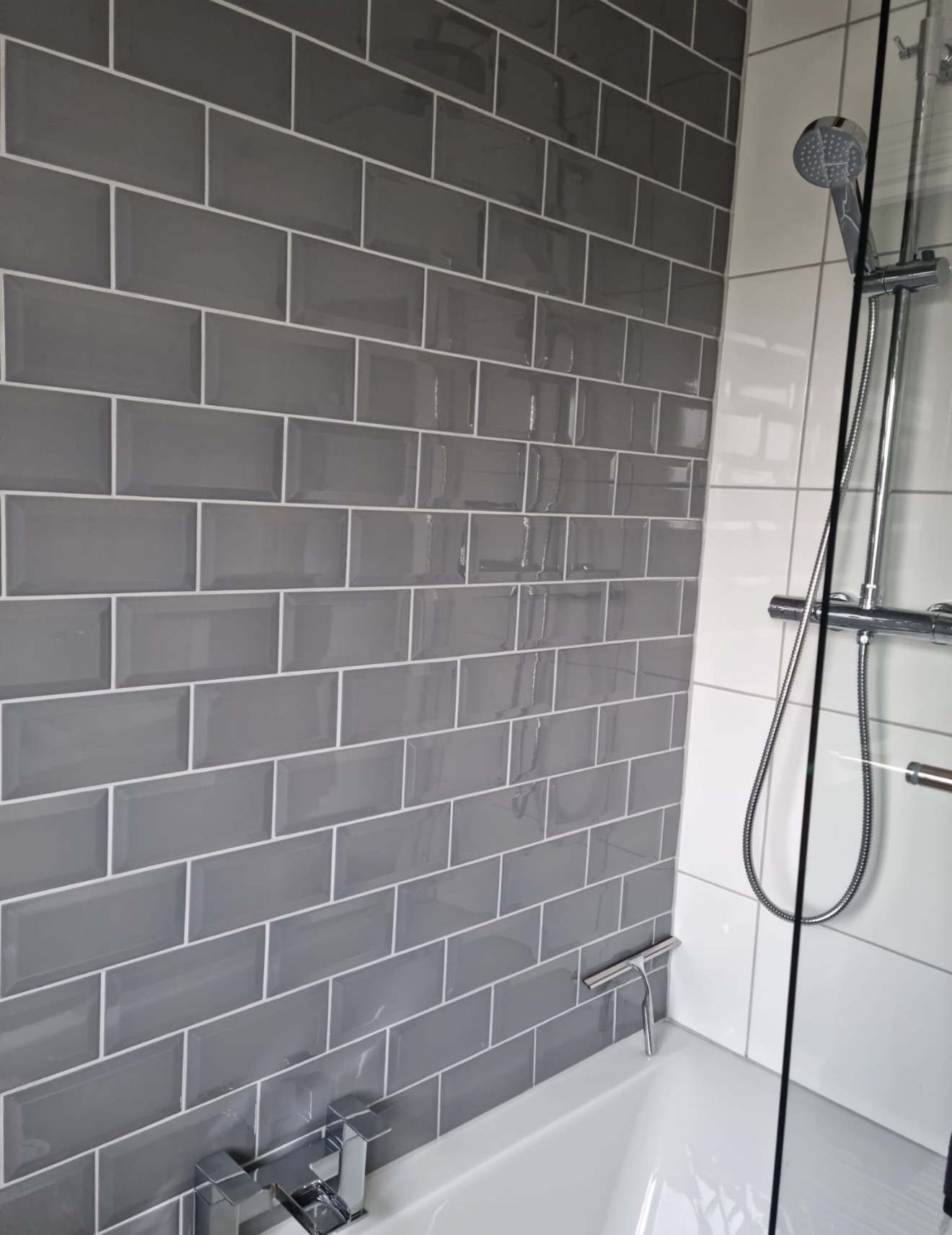 Grey metro tiled bath and shower